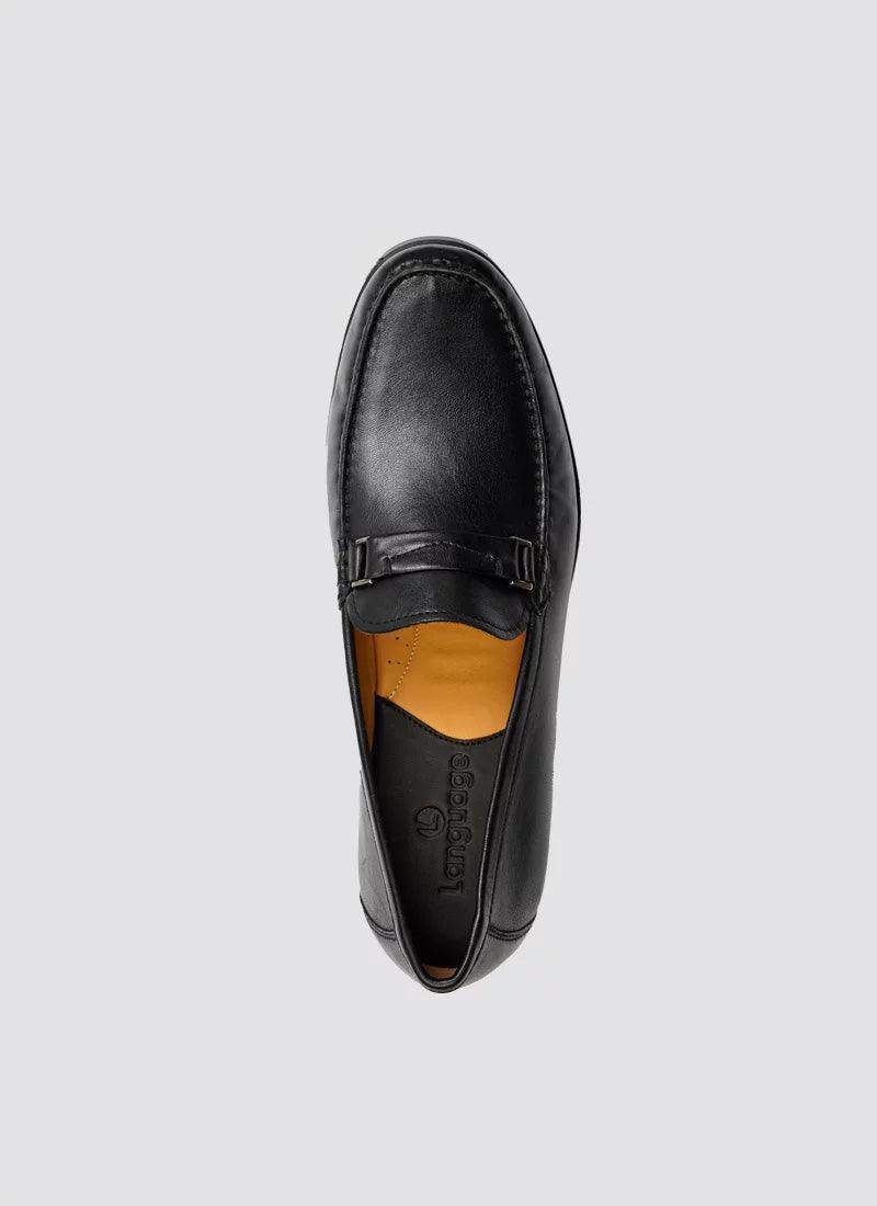 Black leather loafer for men with a buckle detail, top view on plain background