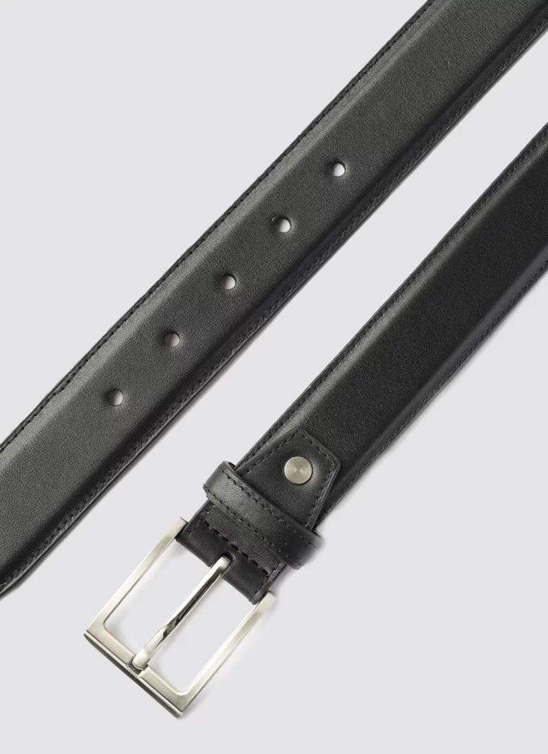 Black leather belt for men with silver buckle on light background