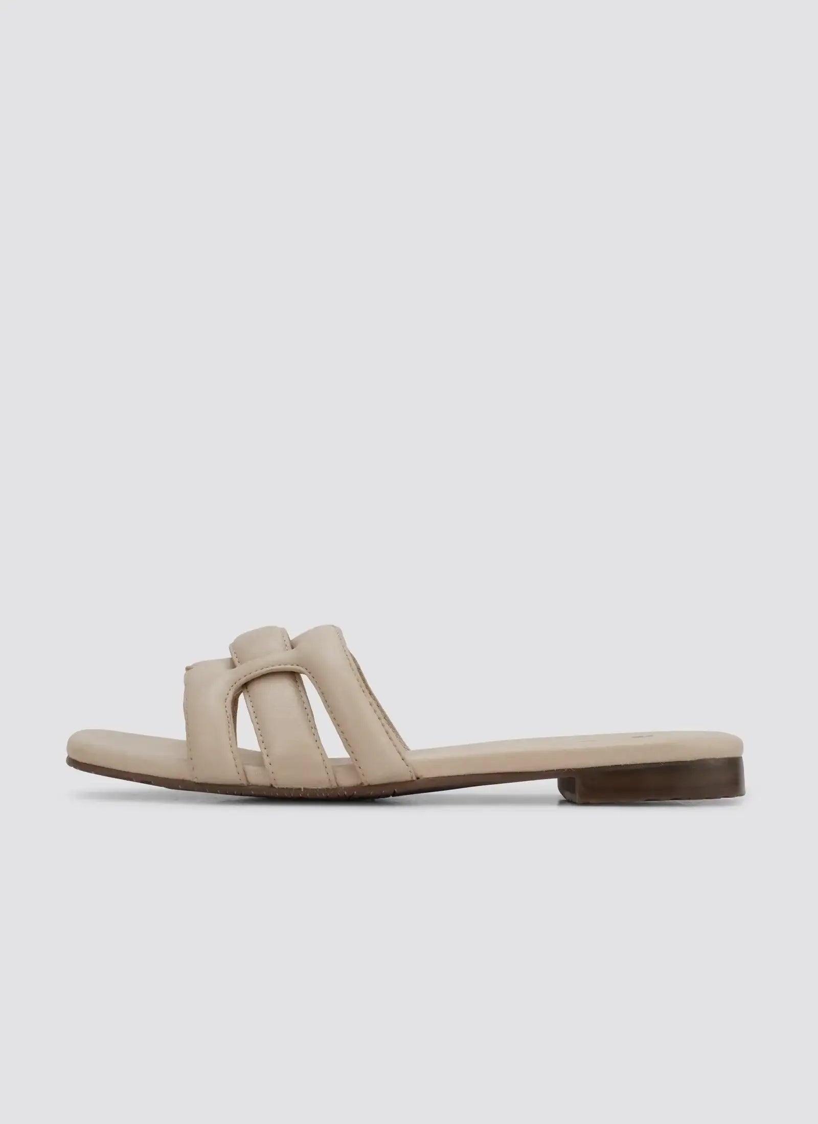 Nude flat slip-on sandal with open toe and padded straps for women on white background