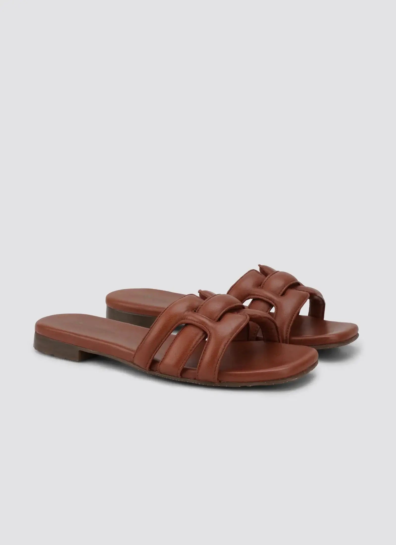 Tan leather slip-on sandals with cushioned straps and flat sole for men or women #color_tan