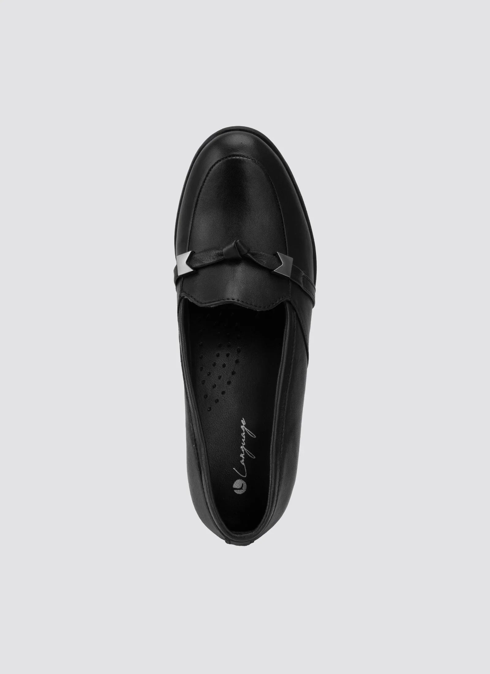 Black leather loafer with decorative strap, top view, women's footwear on light background