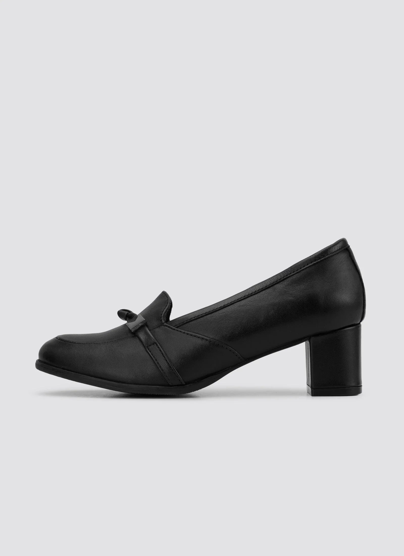 Black leather women's loafer with mid block heel and bow detail on plain background