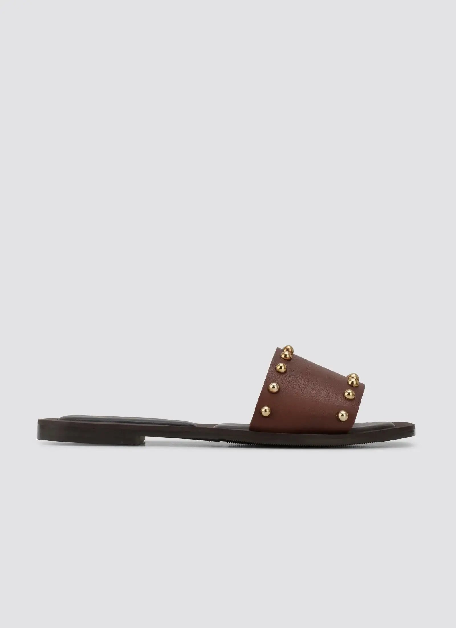 Brown leather slide sandal with gold studs, flat sole, minimalist women's footwear