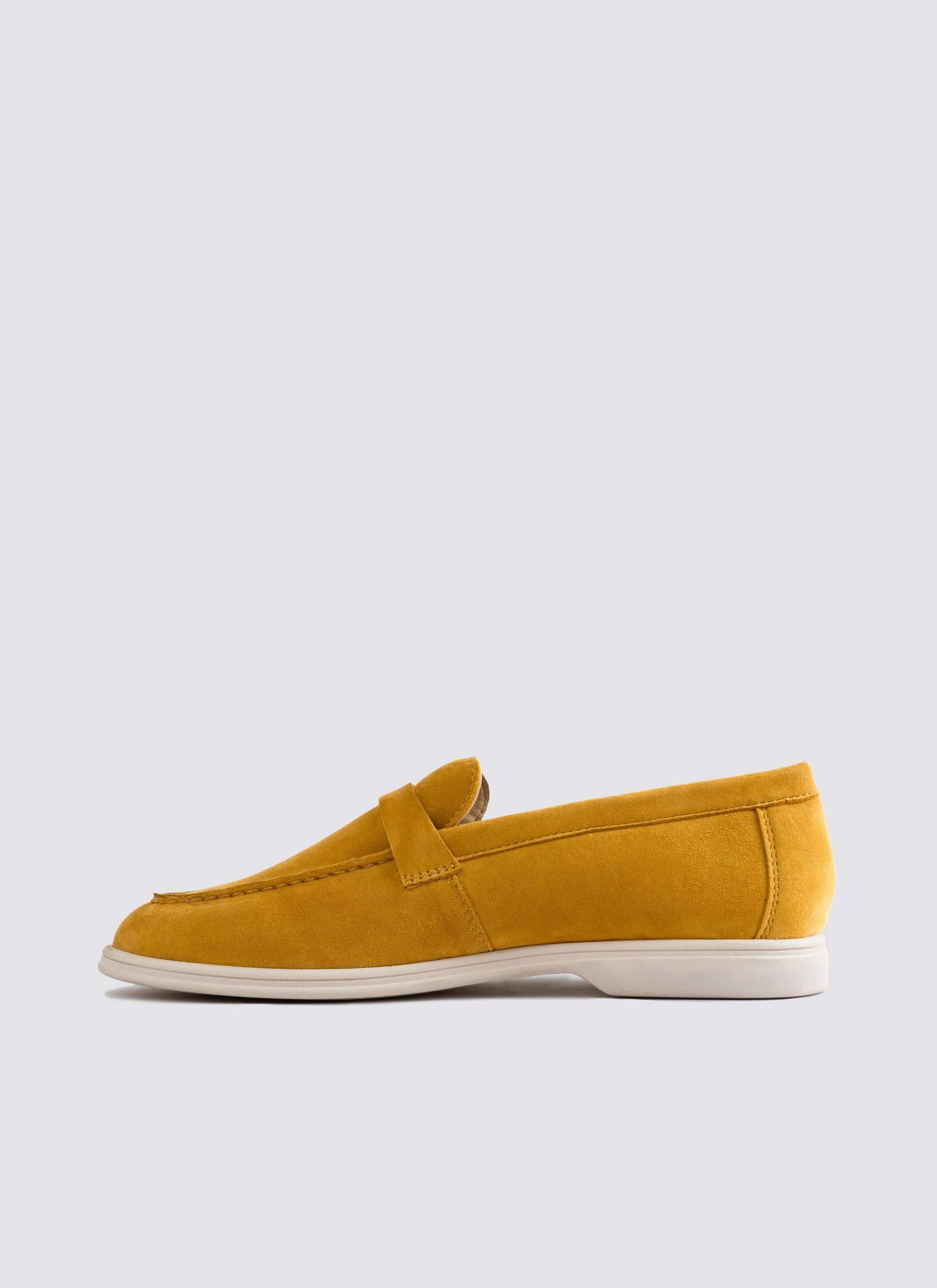 Mustard yellow suede loafer with white sole, classic men's footwear on white background