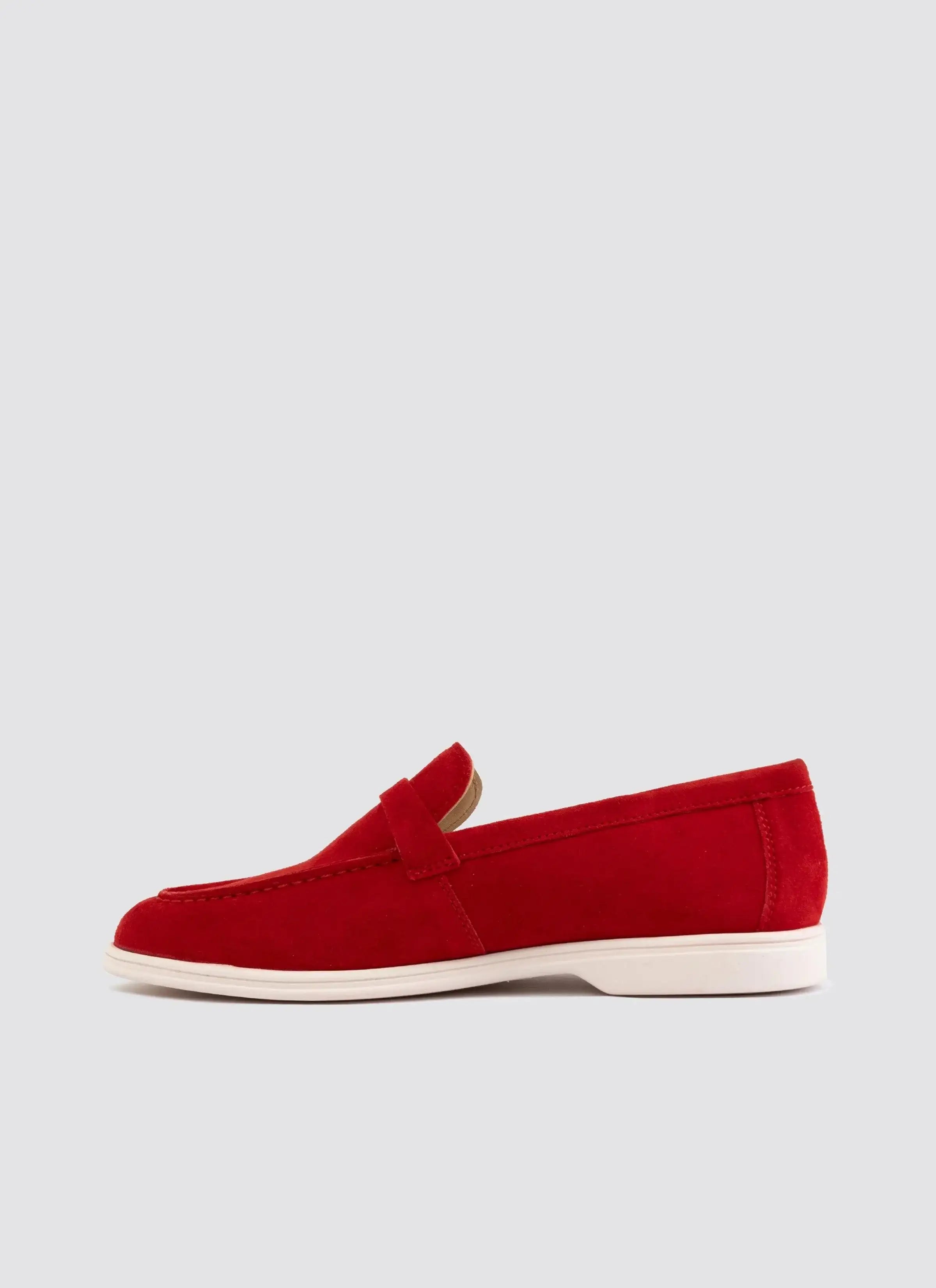Red suede loafer with white sole, men's footwear on plain background