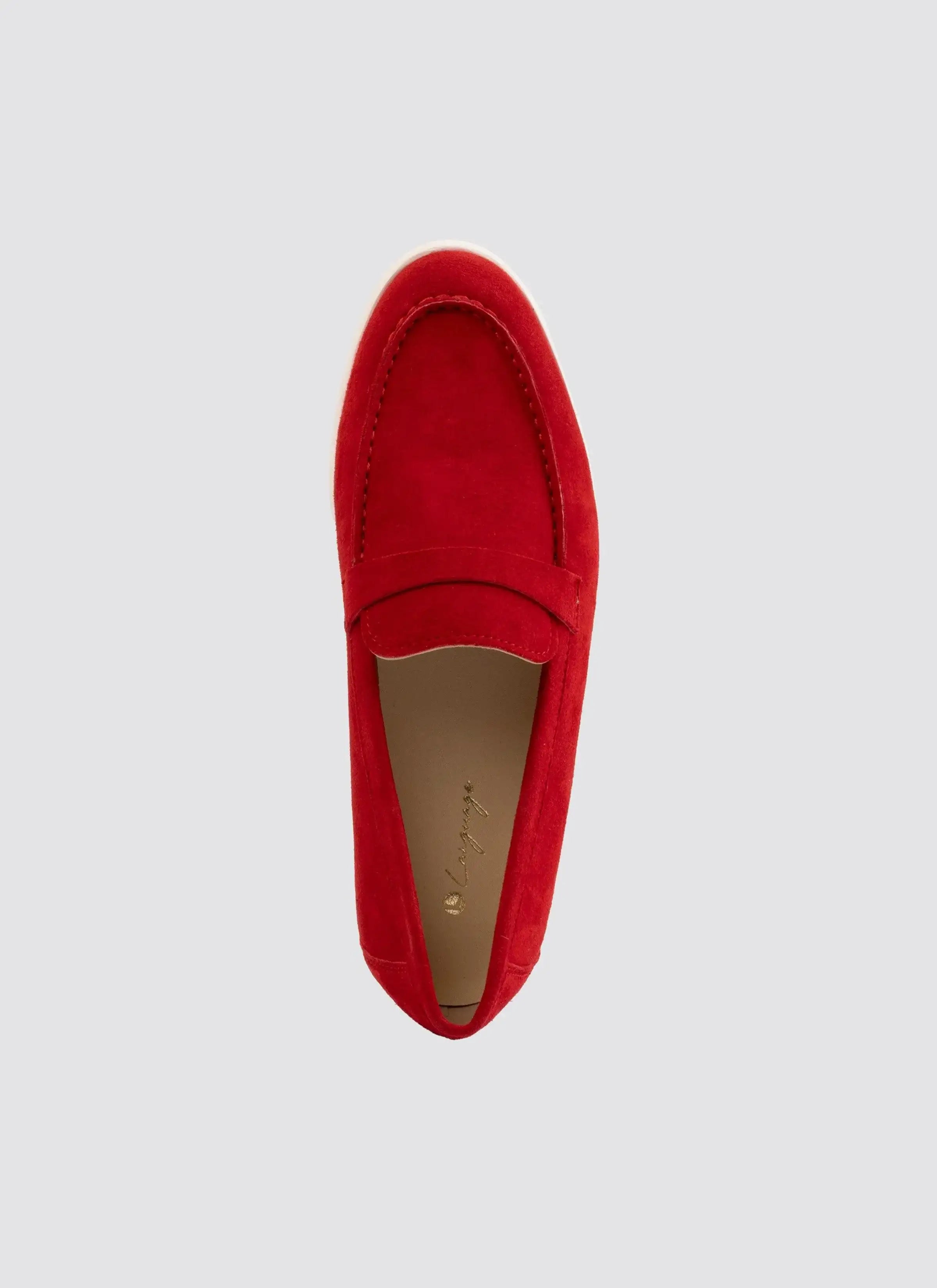 Red suede loafer for men or women, slip-on footwear on light grey background