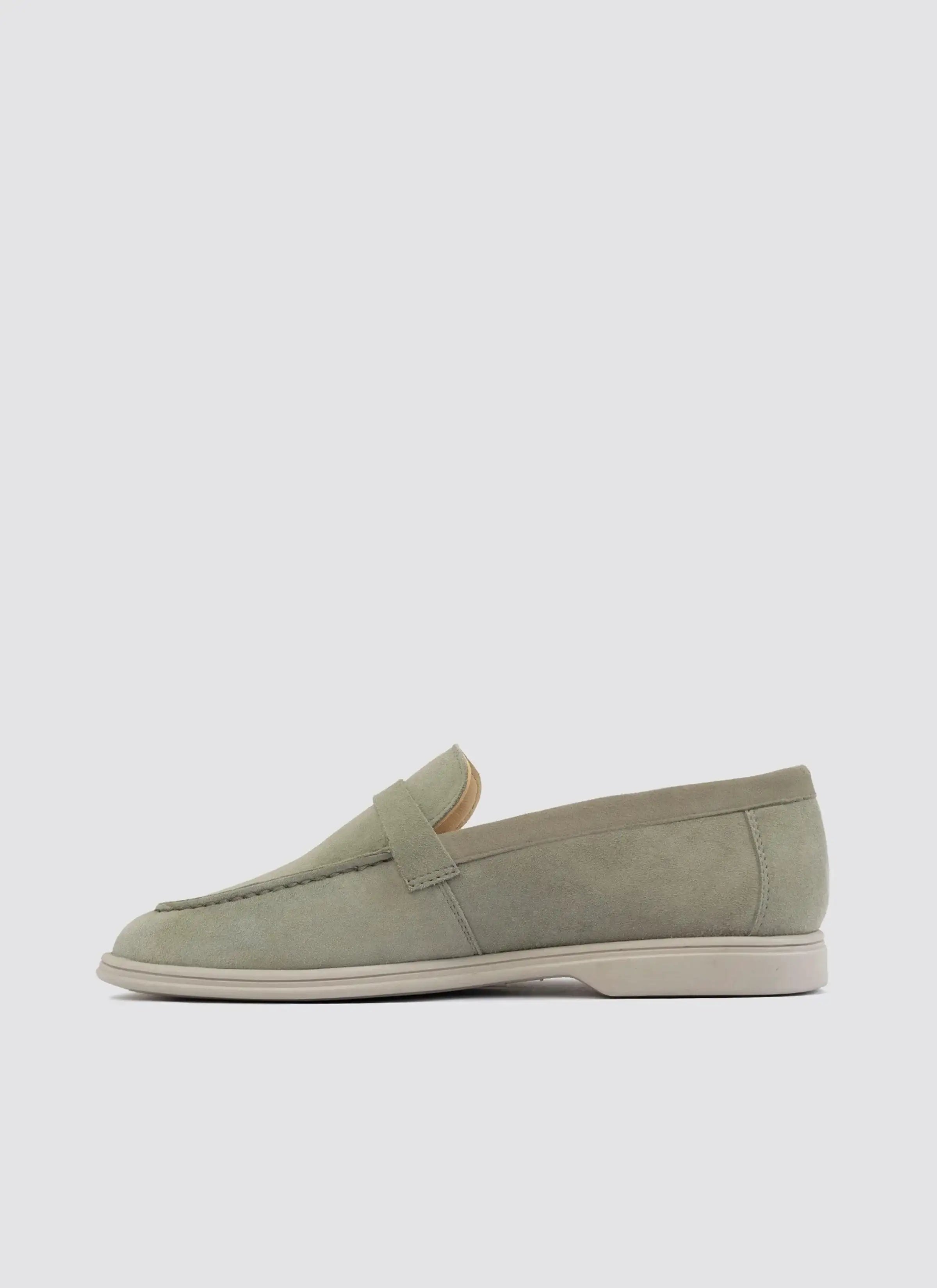 Light olive suede loafer for men with rubber sole, side view on white background