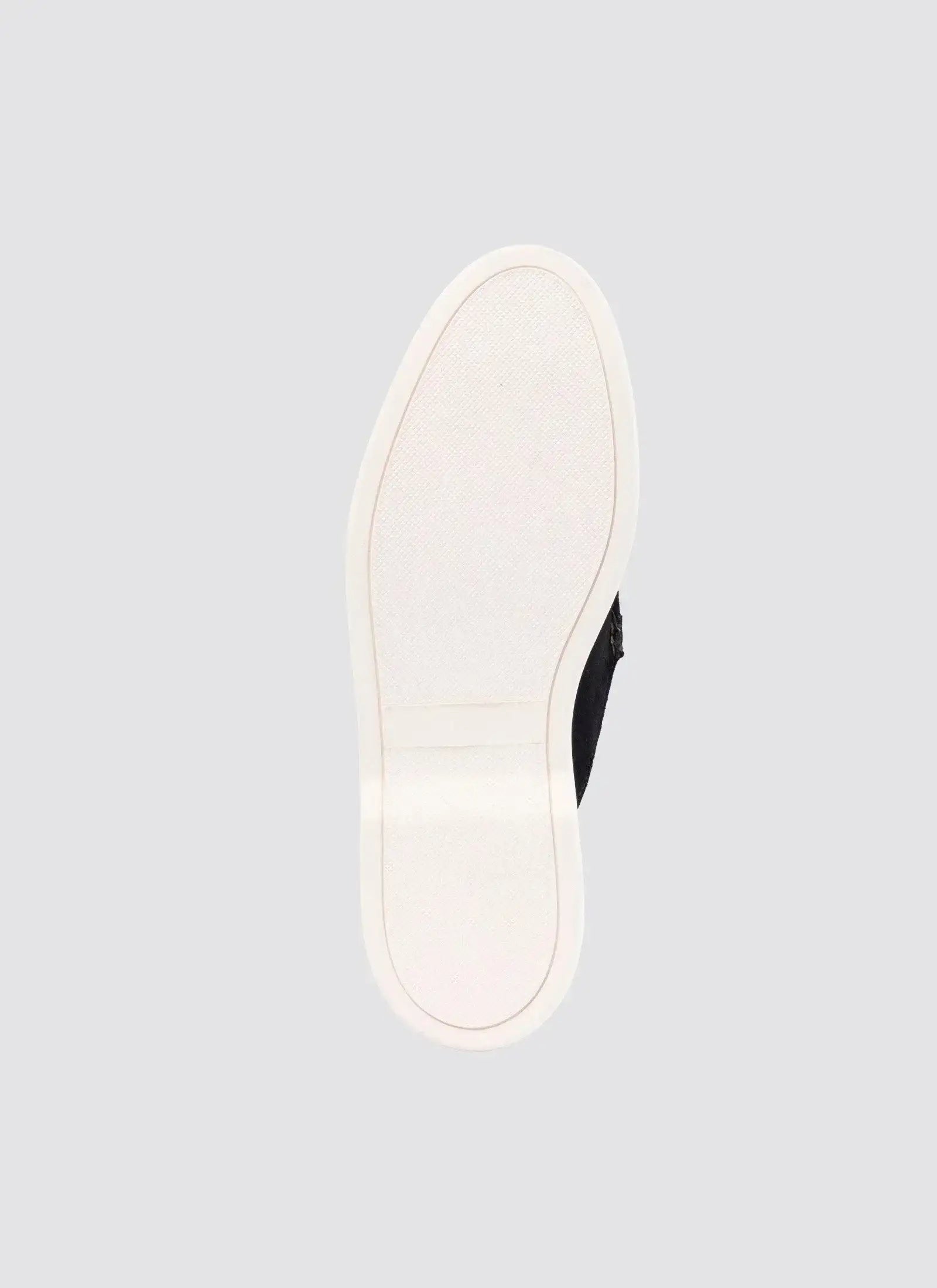 Close-up of black shoe with white rubber sole