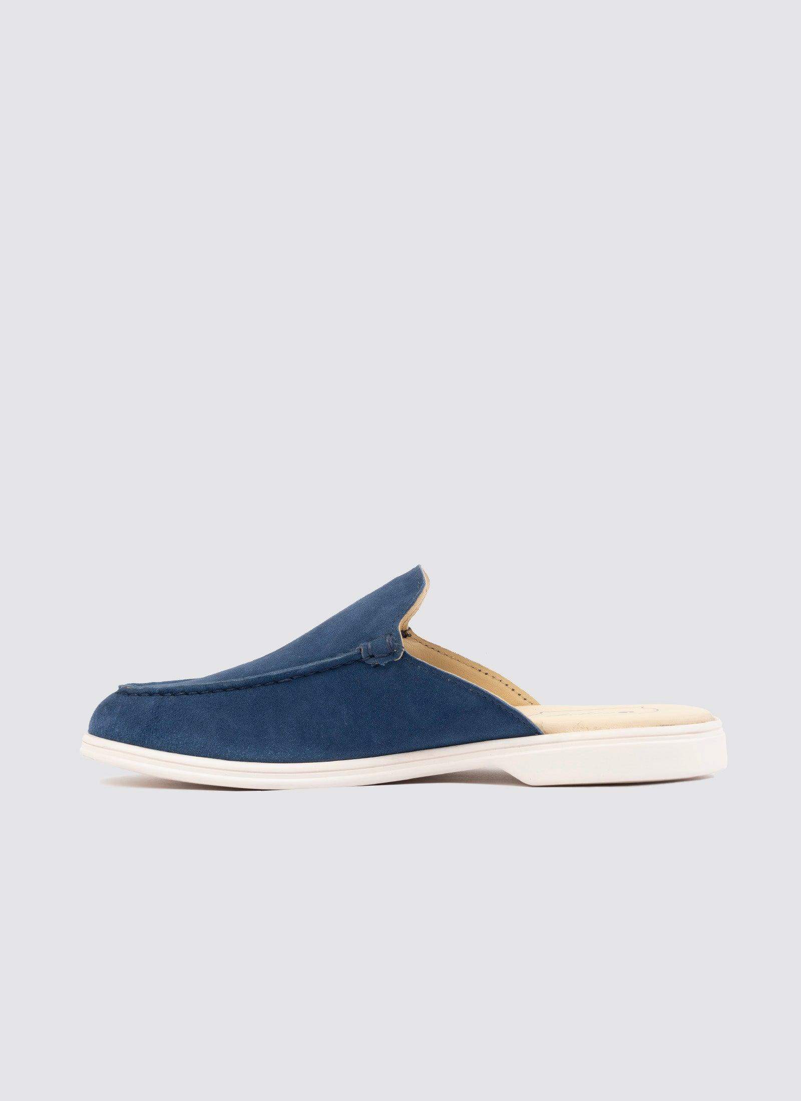 Men’s navy blue suede mule slip-on shoe with white sole on grey background