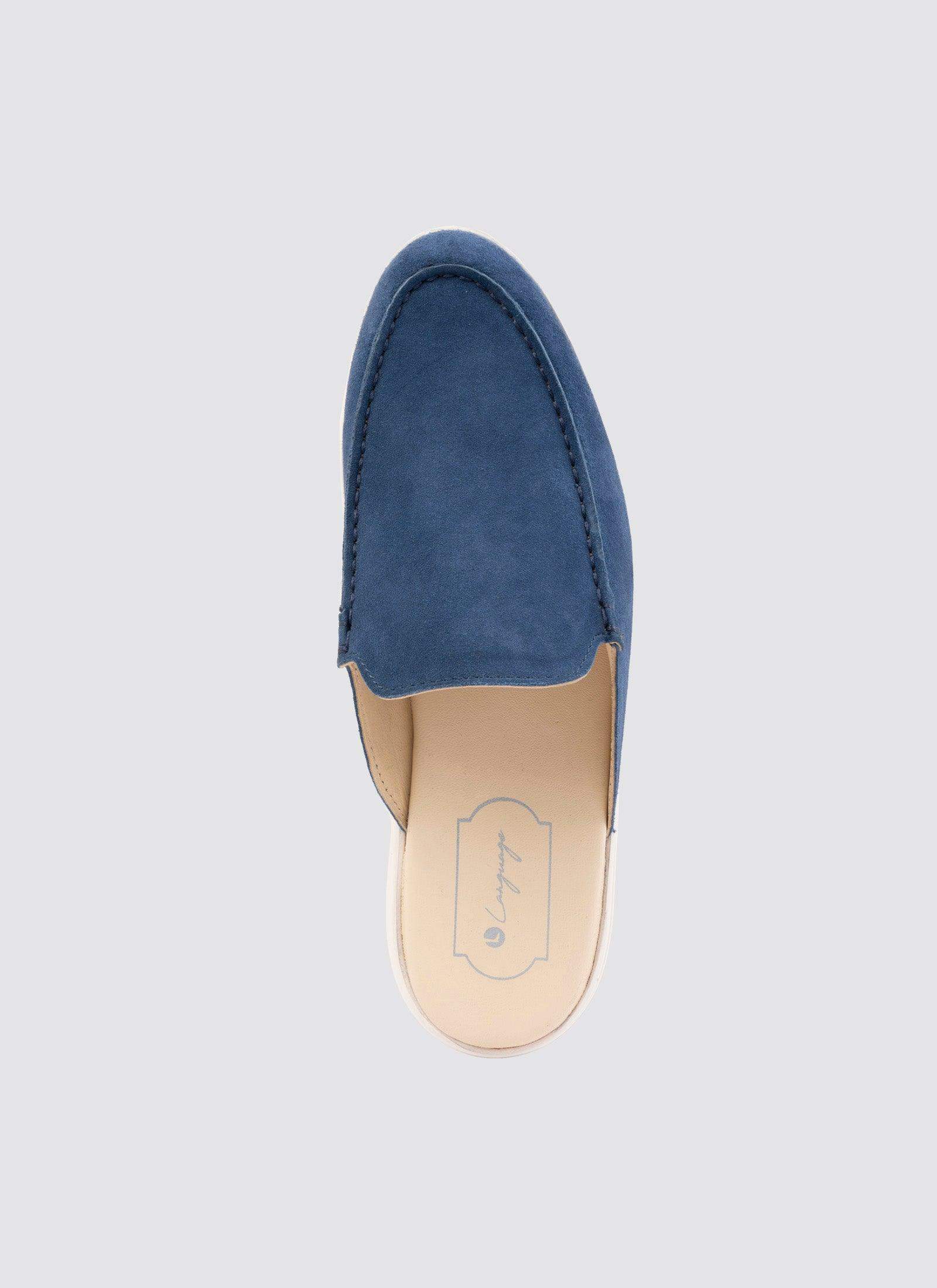 Top view of a navy blue suede slip-on loafer for men on a plain background