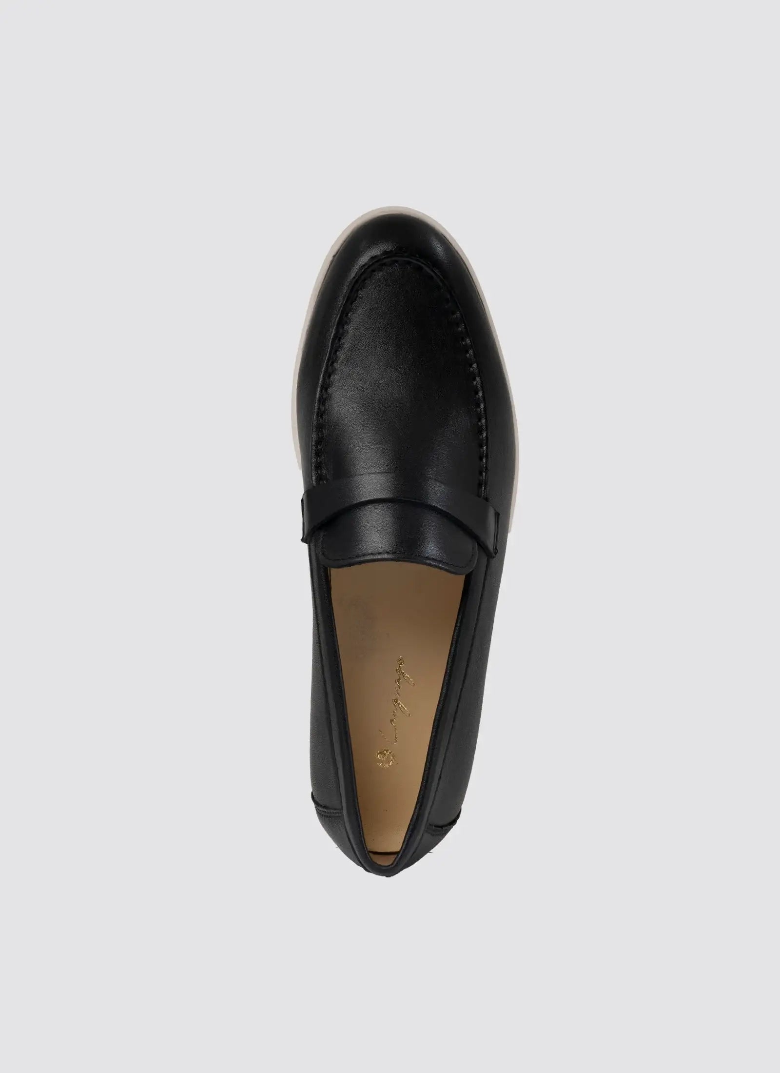 Black loafer shoe on a light gray background