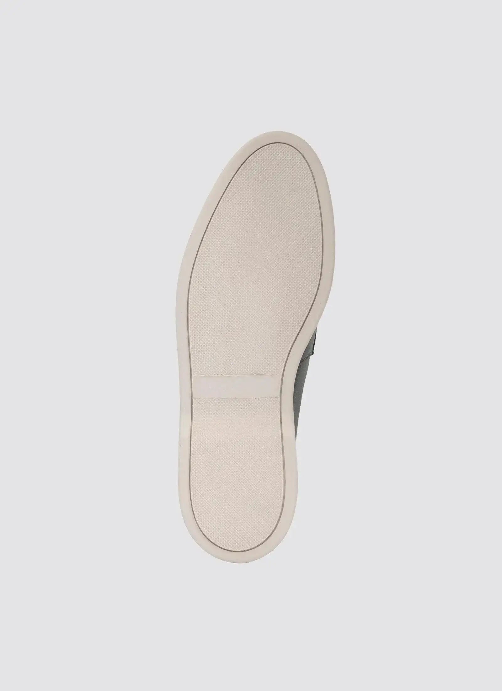 Beige rubber sneaker sole with textured grip, photographed against a plain background.