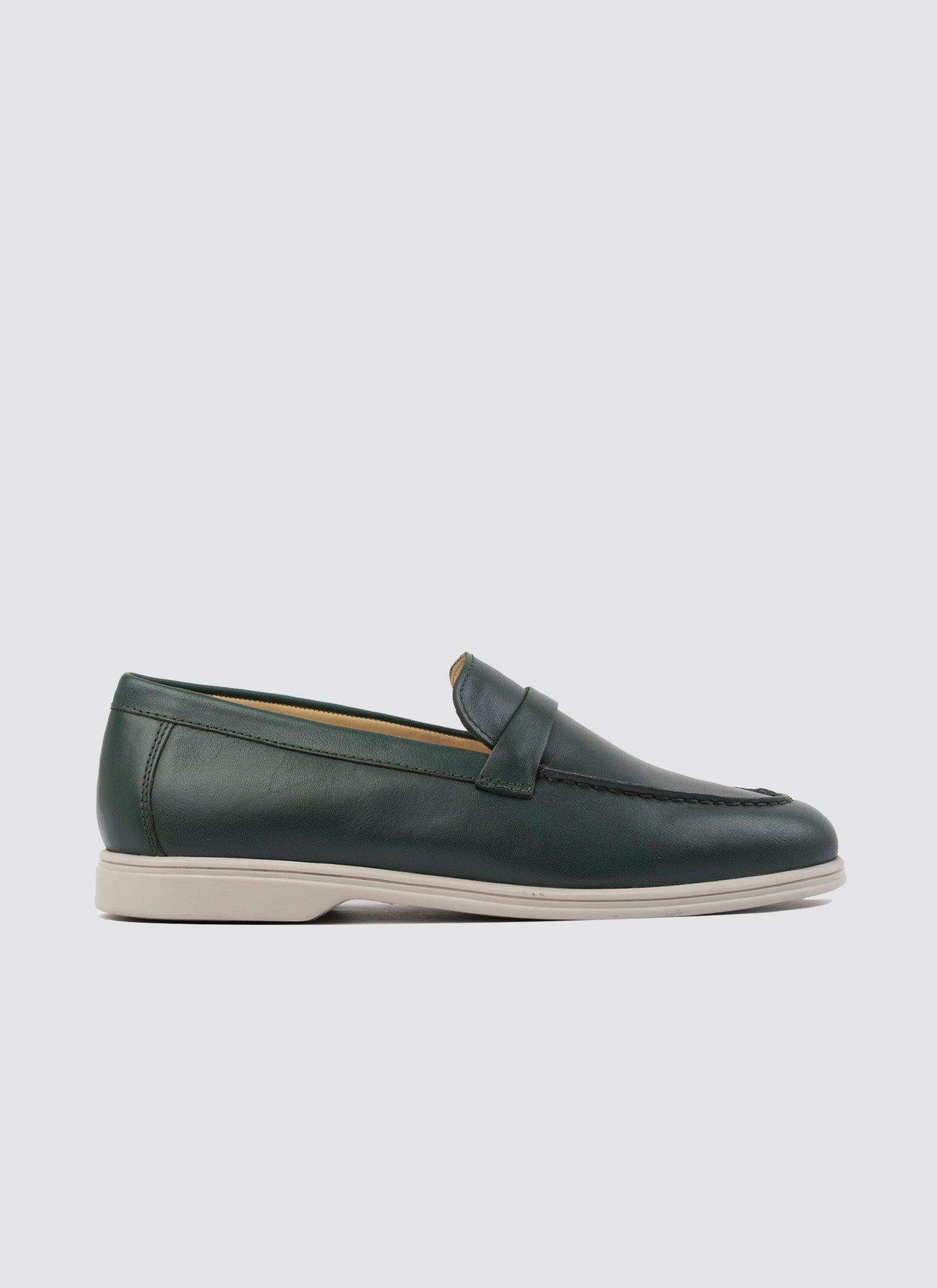 Forest green leather loafer shoe with white sole, classic men's footwear on white background