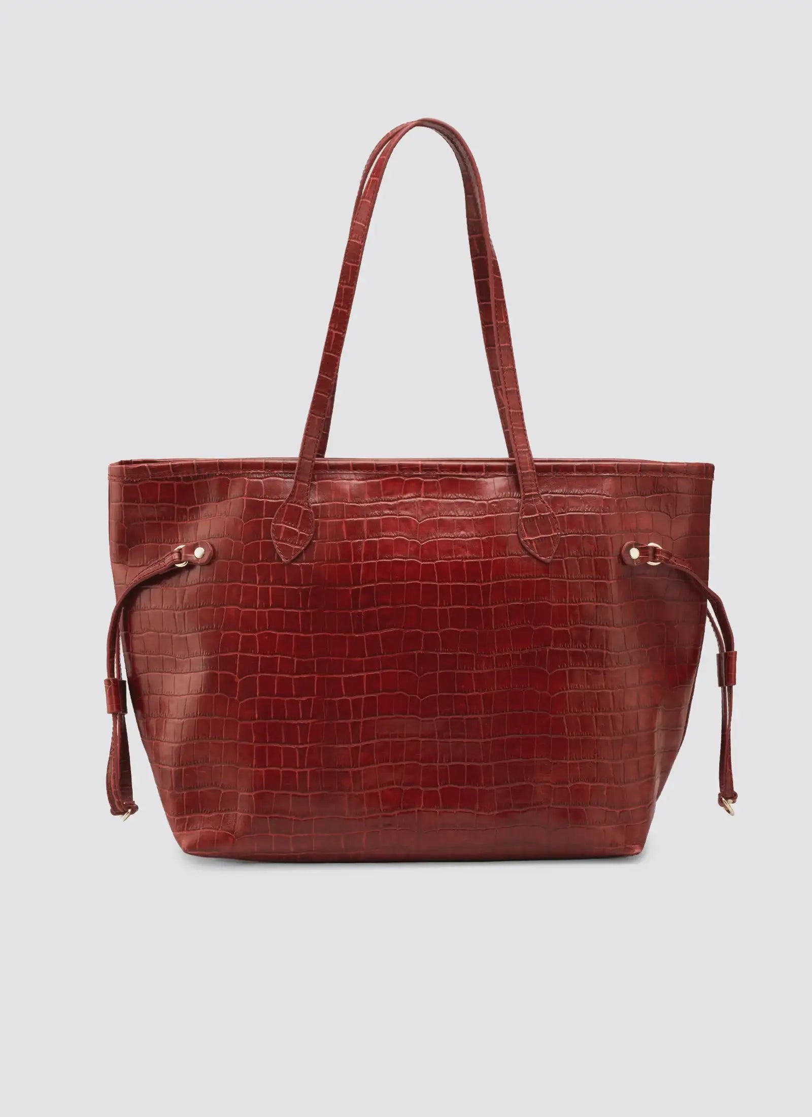 Red leather tote bag with a textured pattern on a light gray background