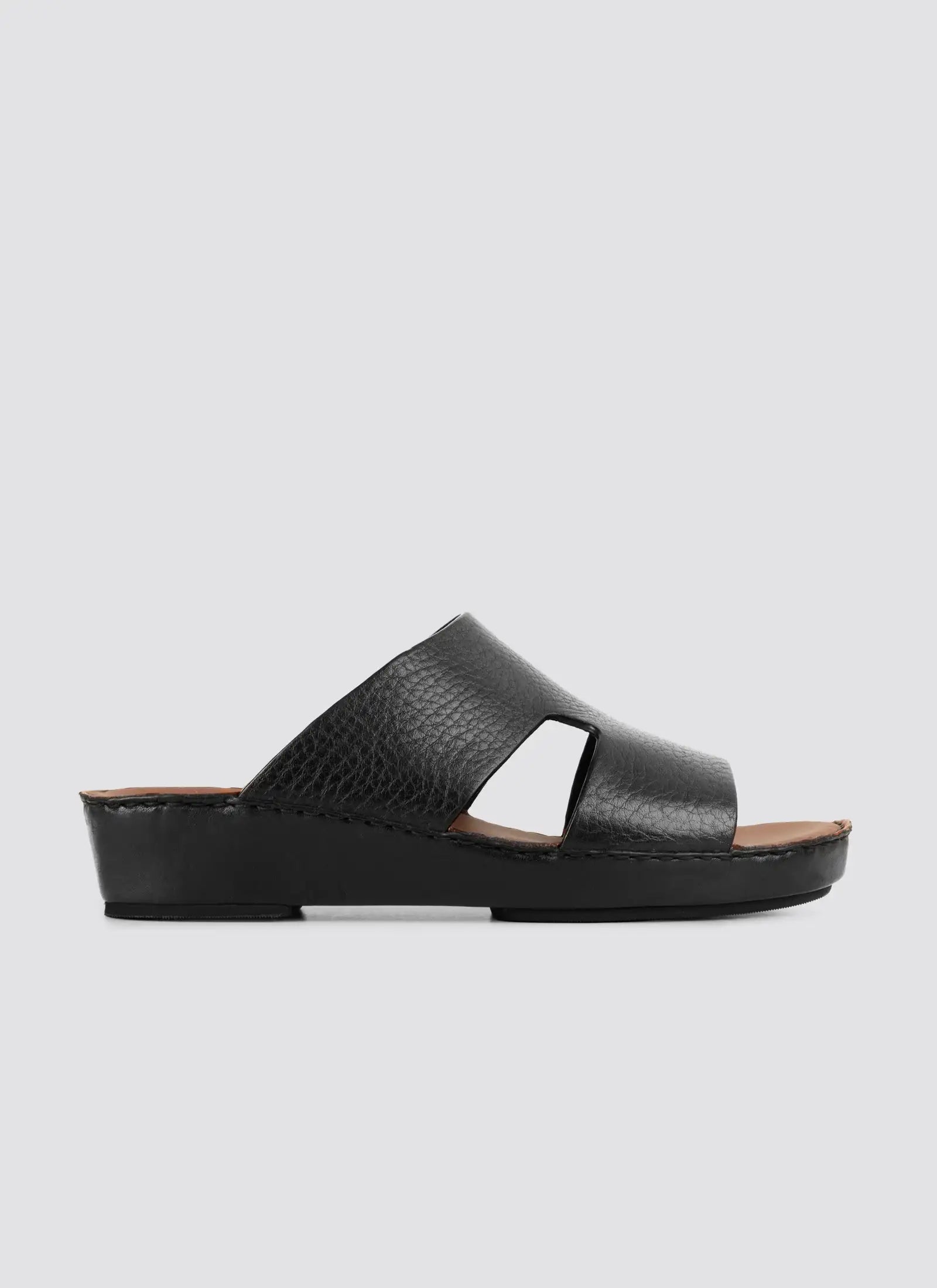 Black sandal on a light gray background