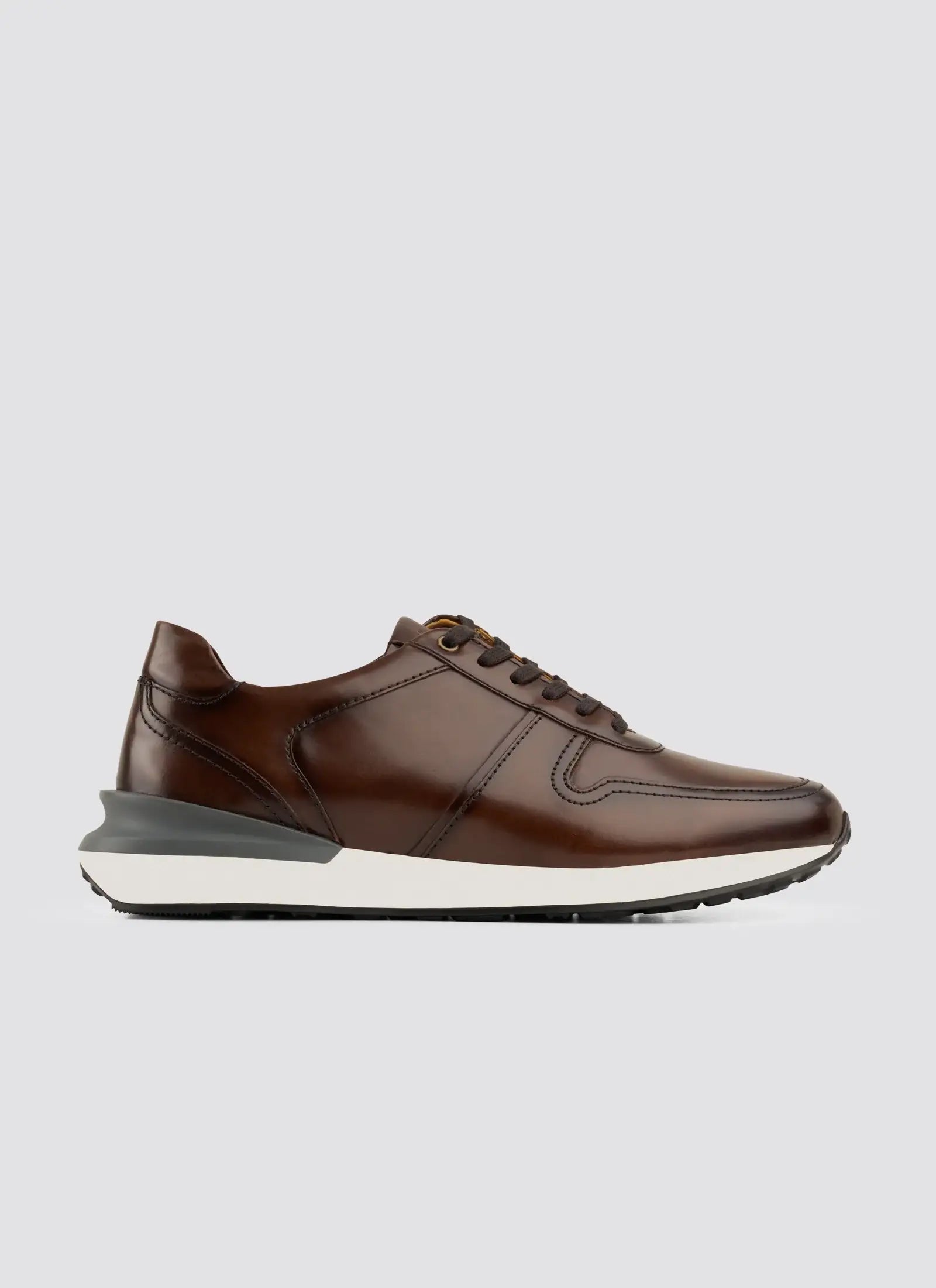 Men's brown leather sneaker with white sole and dark laces on plain background #color_brown