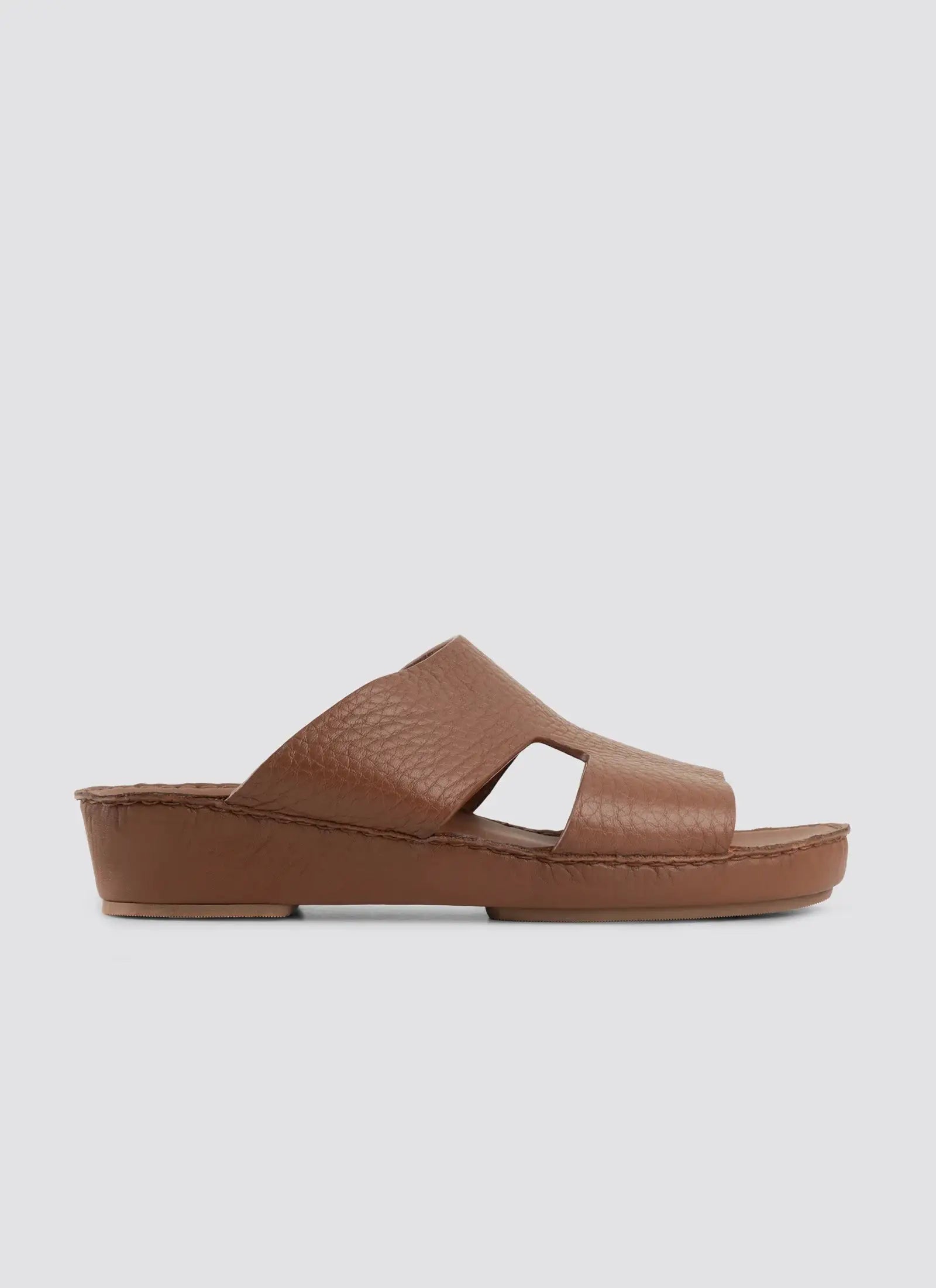 Brown sandal on a light gray background