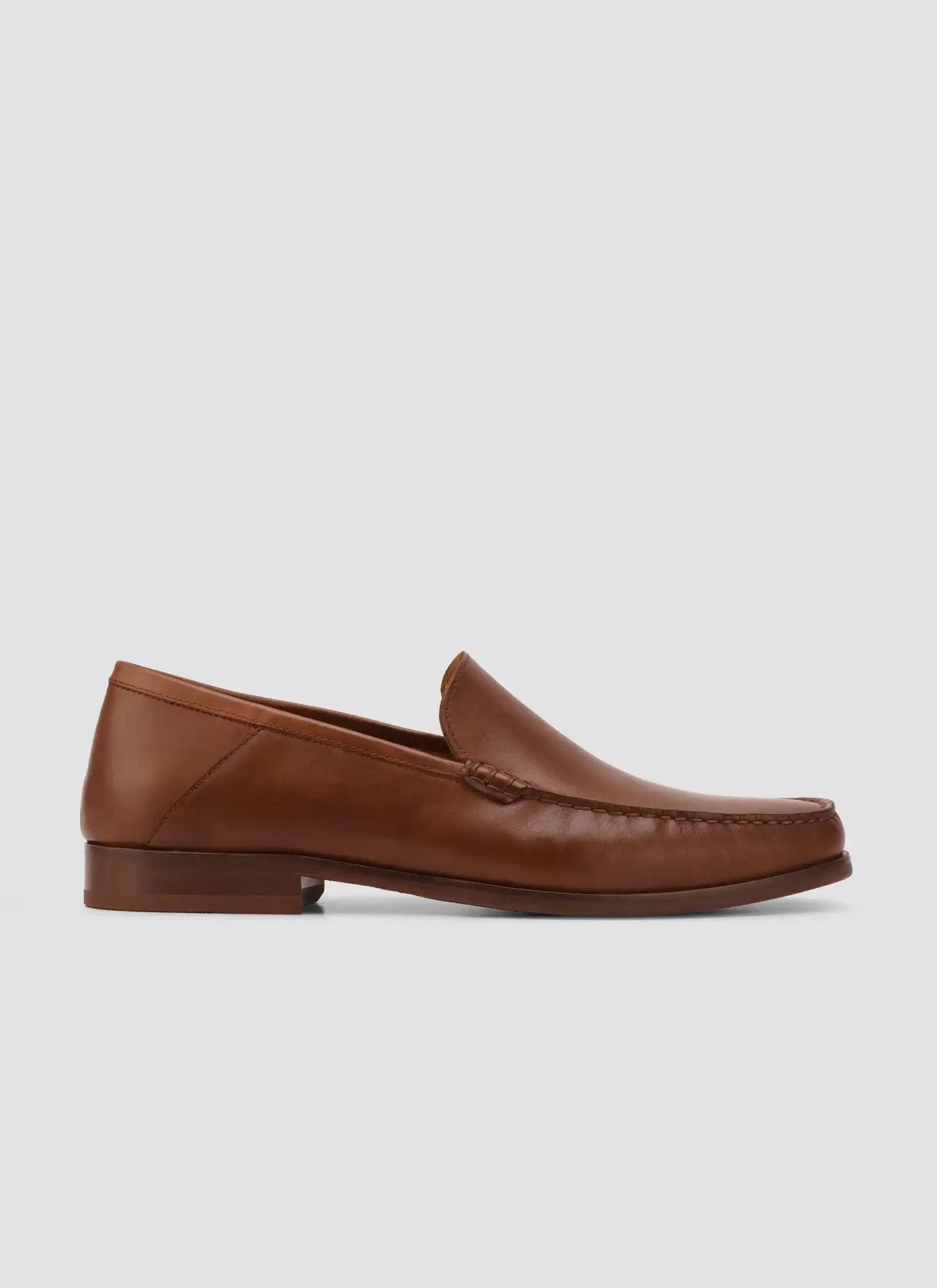 Men's brown leather loafer with classic moccasin stitching on a white background