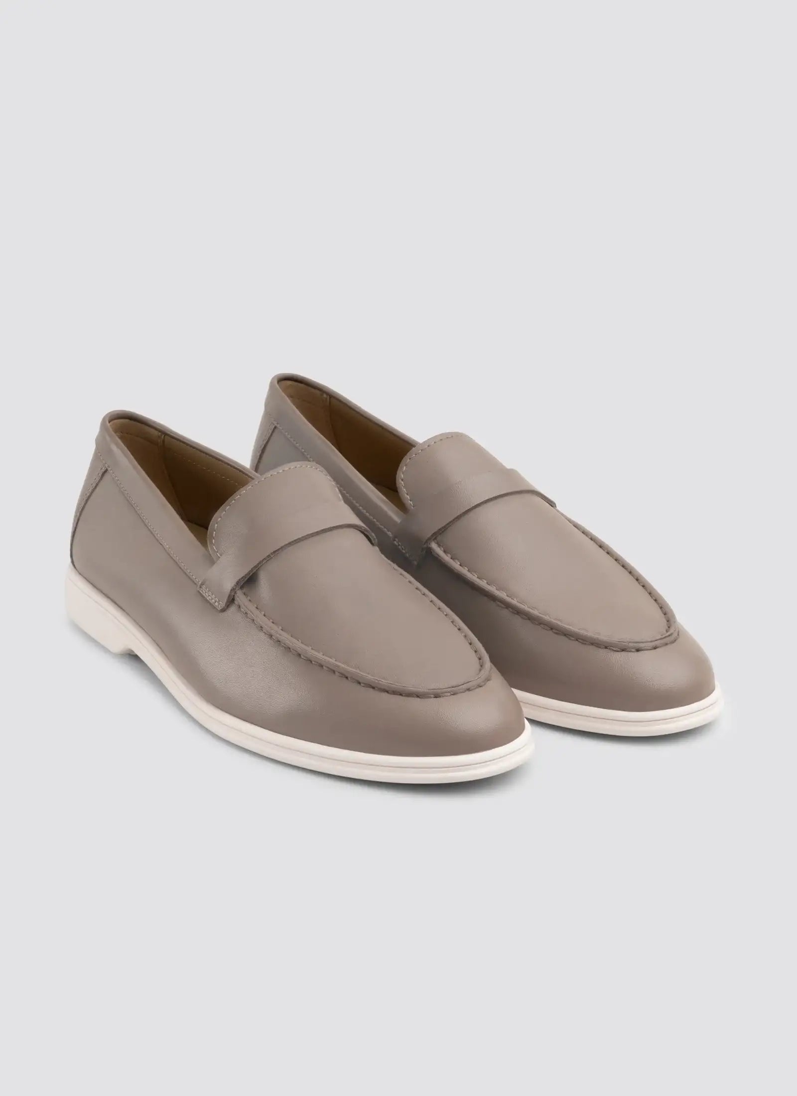 Pair of gray loafers on a light gray background