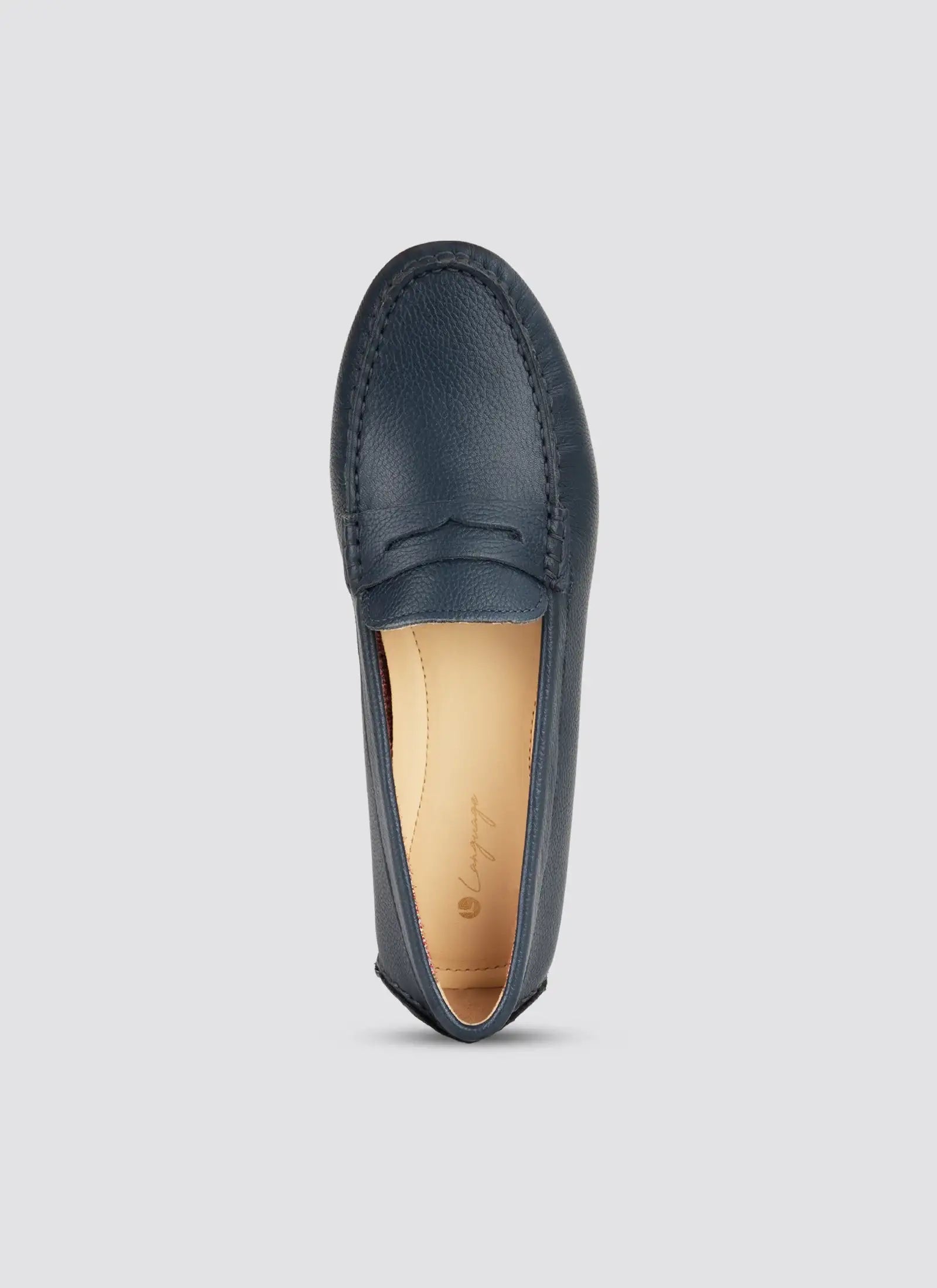 Navy blue loafer shoe on a light gray background