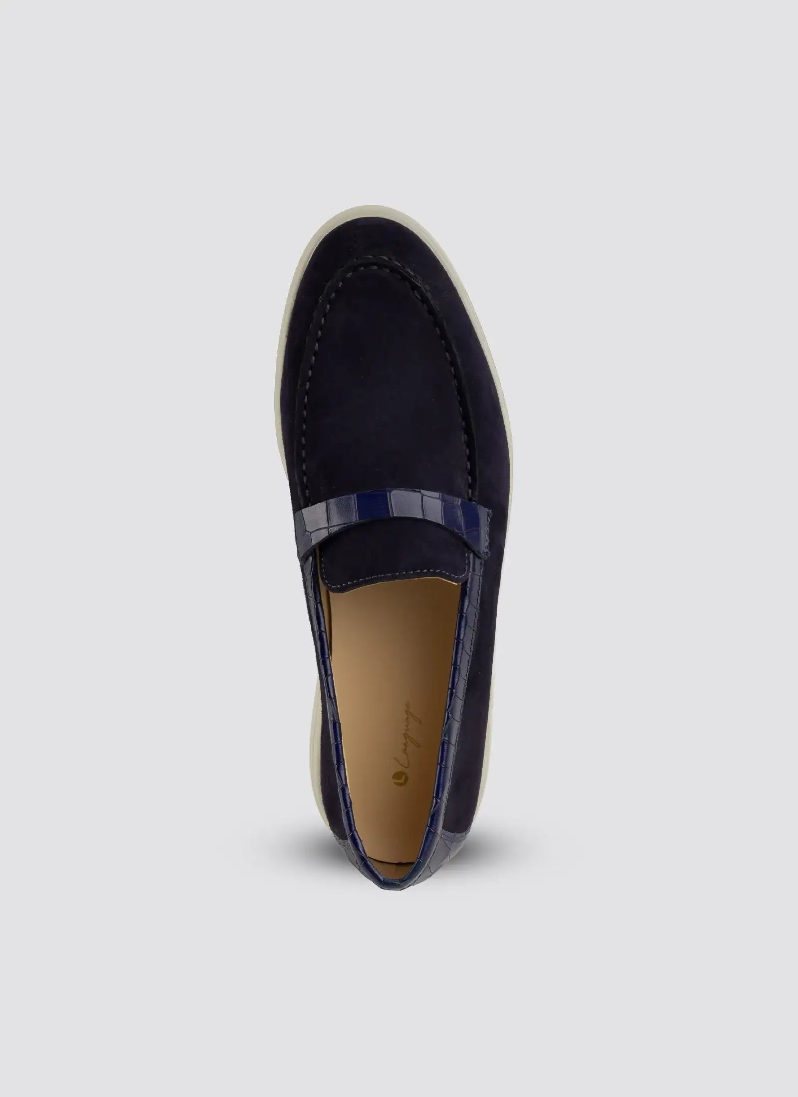 Navy loafer shoe on a light gray background