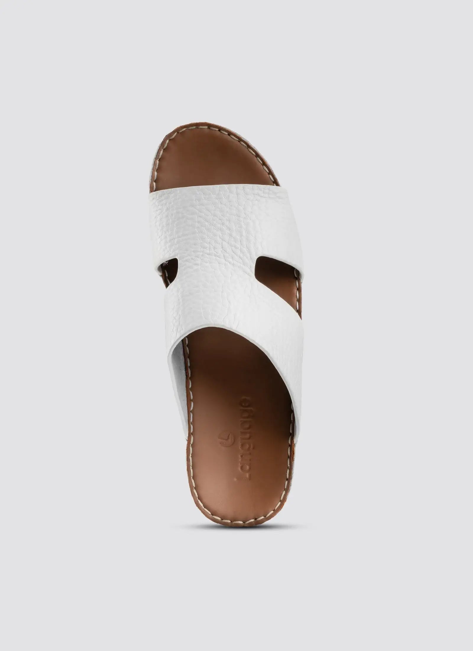 White sandal with brown sole on a light gray background.