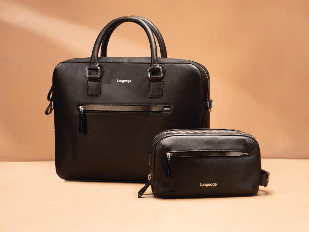 Black leather laptop bag and pouch set with zipper pockets on a tan background