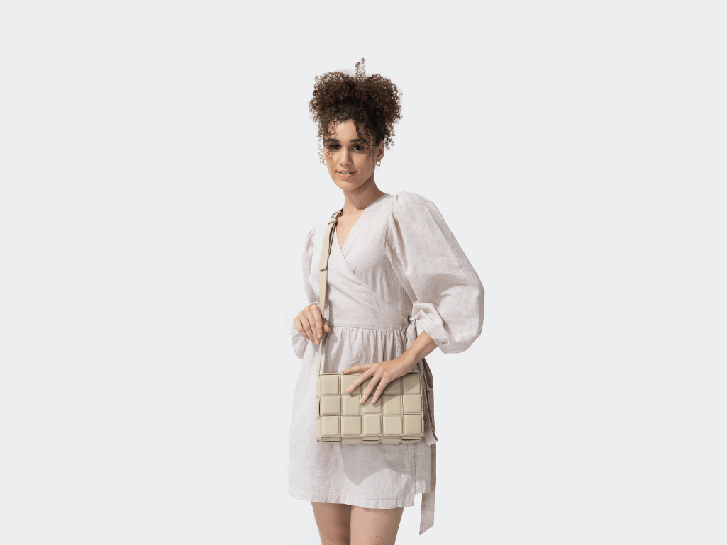 Woman in white dress with beige quilted crossbody bag, fashion accessories for women