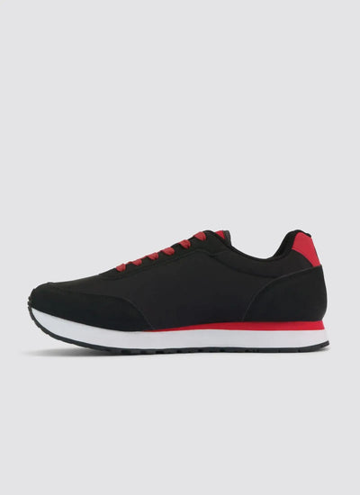 Black and red men's sneaker with white sole, side profile on plain background 