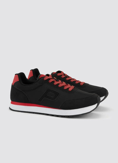 Black and red lace-up sneakers with white soles for men, side view on plain background 