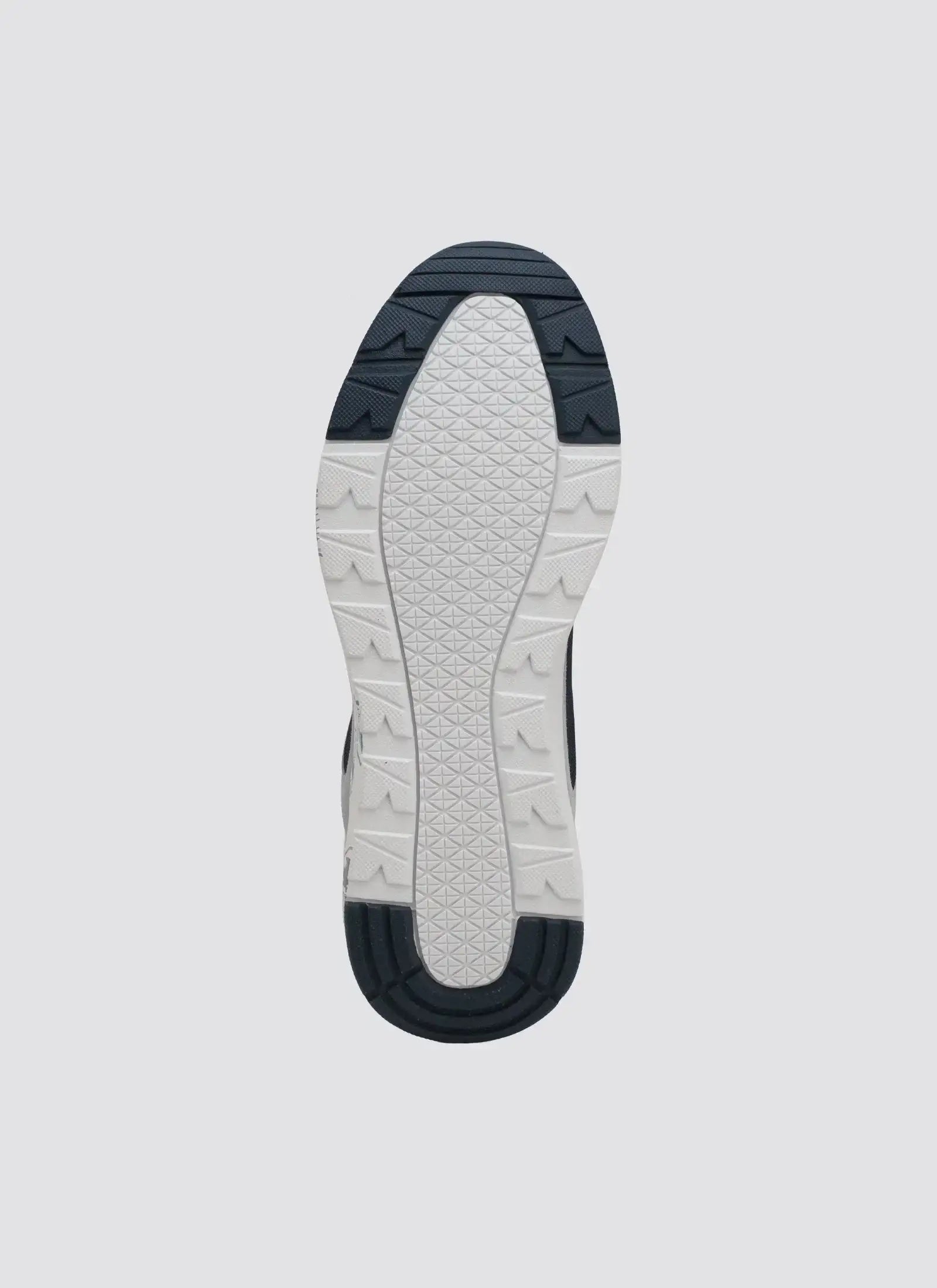 White and navy patterned sneaker sole with textured rubber grip design on grey background 