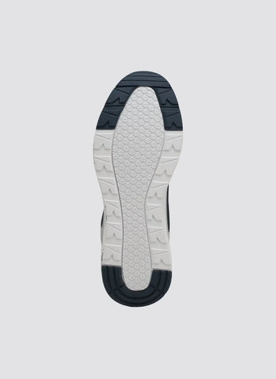 White and navy patterned sneaker sole with textured rubber grip design on grey background 