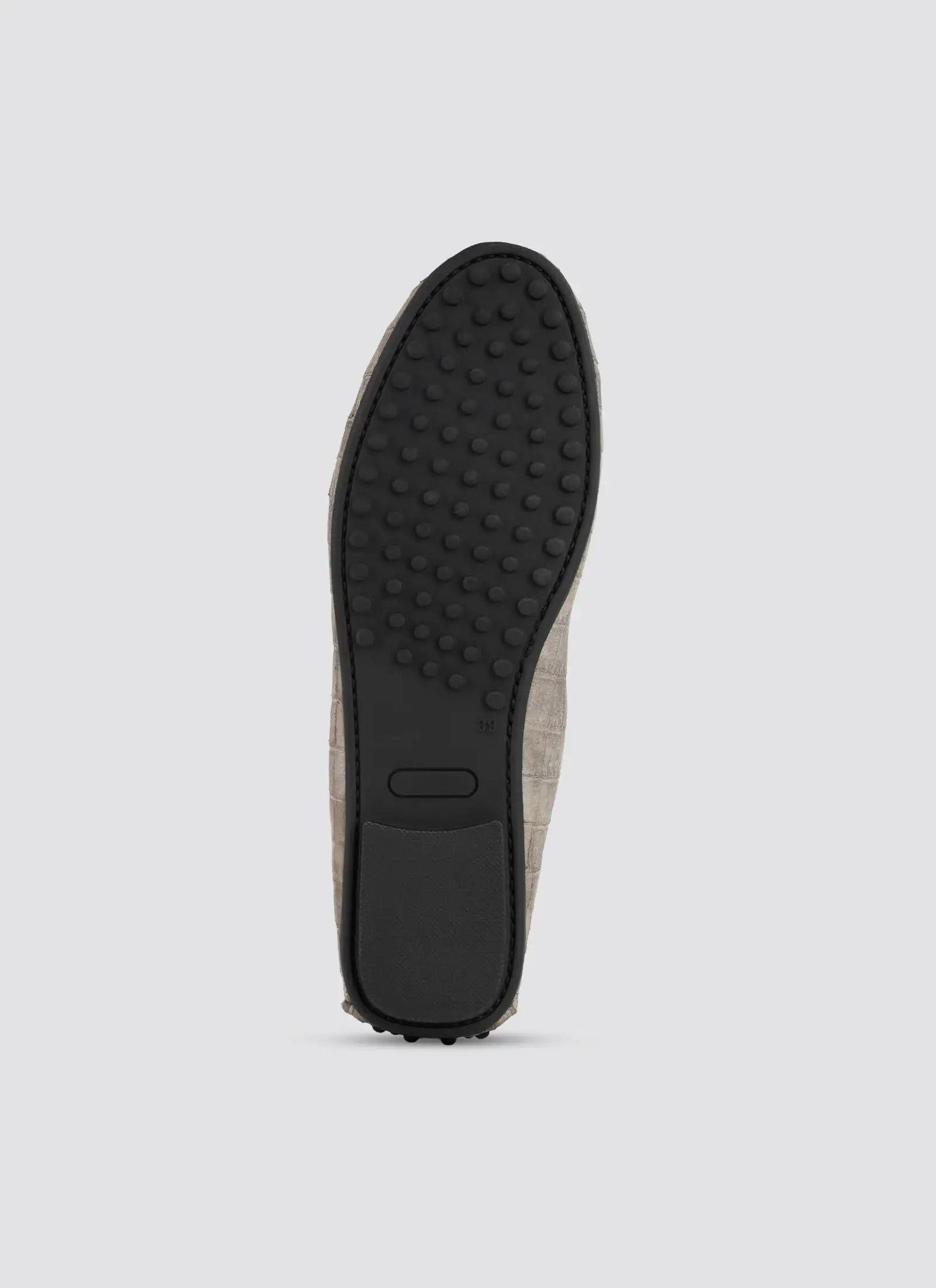 Close-up of a brown shoe sole on a light gray background 