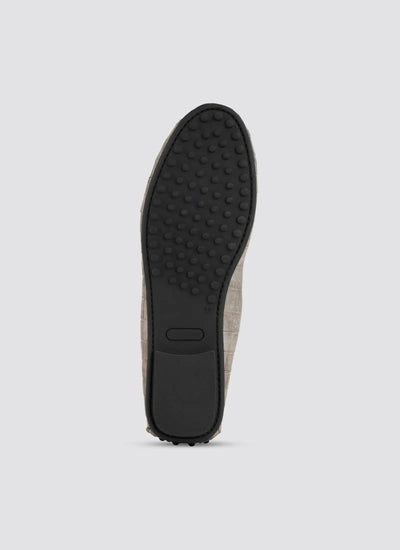 Close-up of a brown shoe sole on a light gray background 