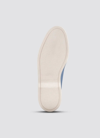 Close-up of a white shoe sole on a light gray background 
