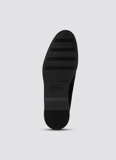 Black rubber shoe sole with textured grip and embossed branding, viewed from bottom 