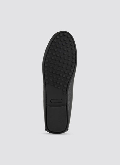 Black shoe sole on a light gray background 