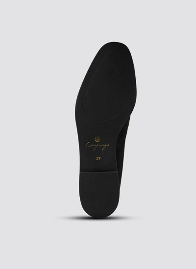 Black shoe sole with 'Camper' branding on a light gray background  