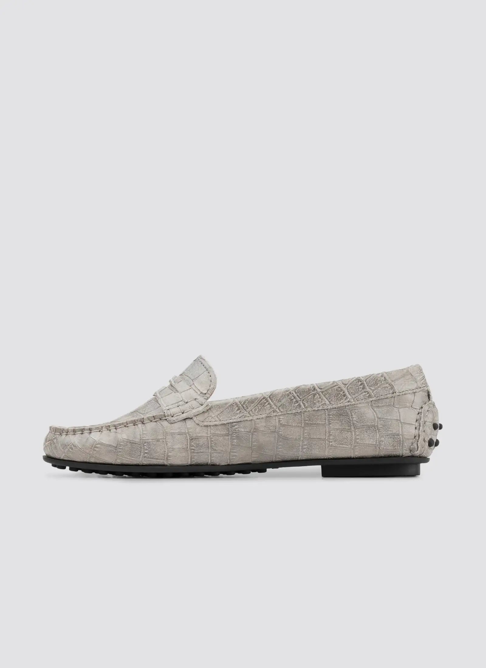 Gray loafers with textured pattern on a white background 