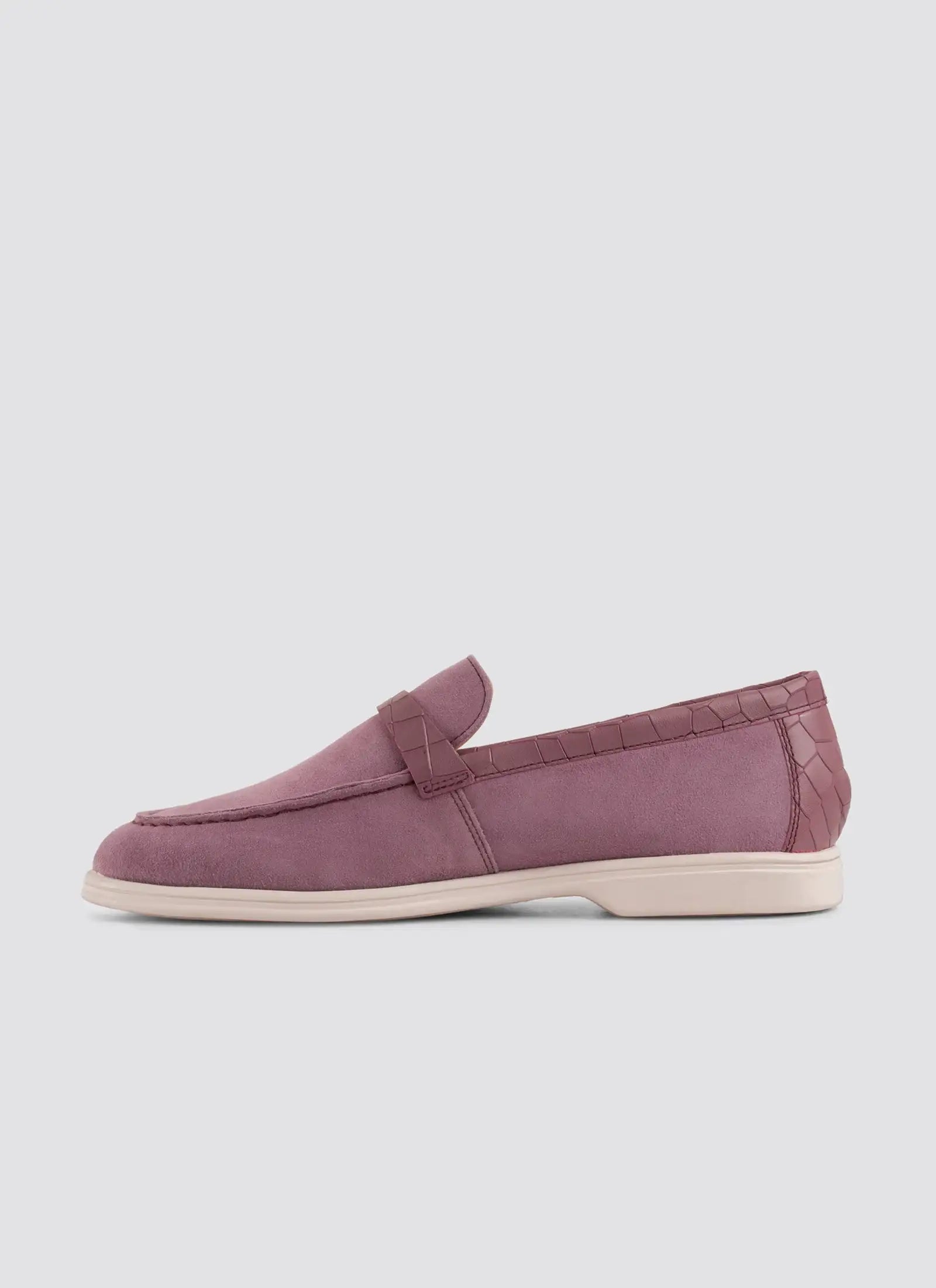 Purple loafer shoe on a light gray background 