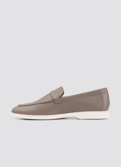 Brown loafer shoe on a light gray background 