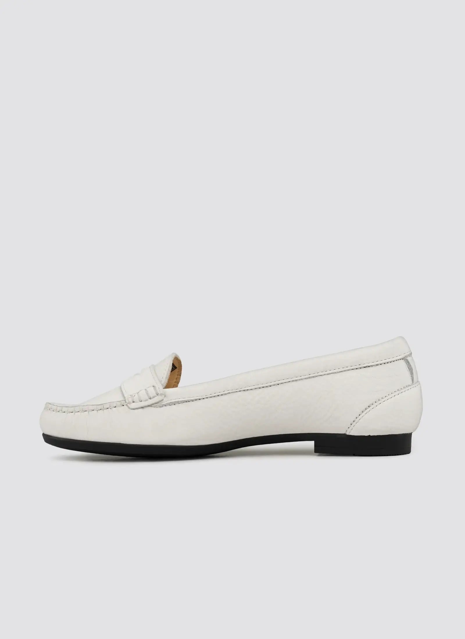 White loafer shoe on a light gray background 