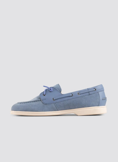 Blue suede boat shoe on a light gray background 