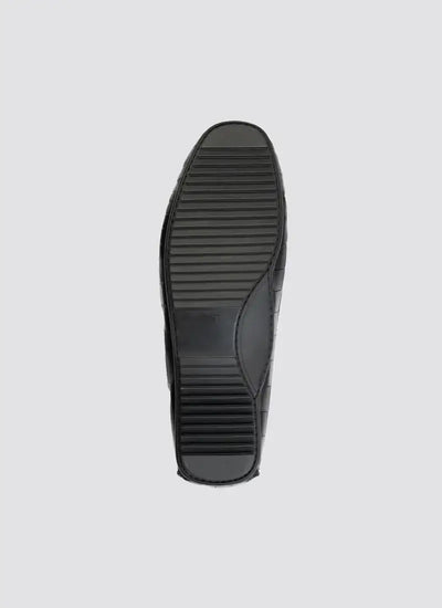 Black shoe sole with textured grip, premium men's footwear, isolated on grey background 