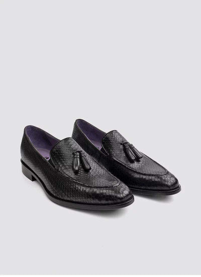 Black textured leather tassel loafers for men with purple lining on a white background 