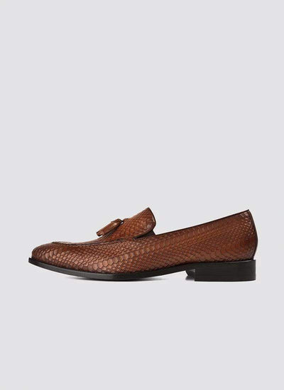 Tan textured leather loafer with tassel detail, men's formal footwear on white background 