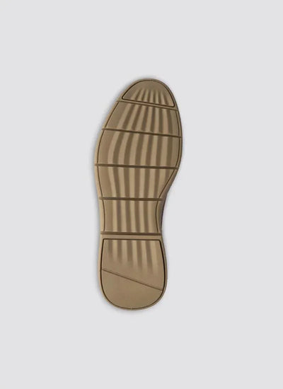 Tan rubber shoe sole with textured grip pattern on a plain background 