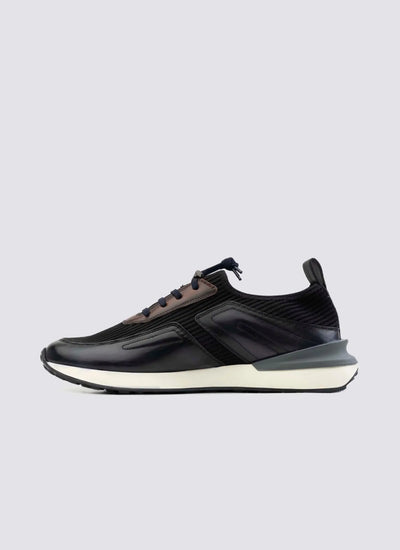 Men's navy blue leather sneaker with white sole, side profile on plain background 