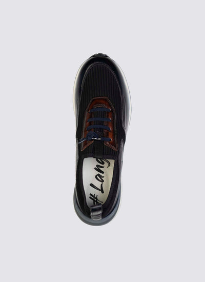 Top view of a navy blue sneaker with brown accents and blue laces on a light background 