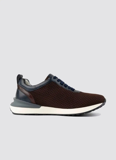 Brown mesh men's sneaker with navy accents, white sole, and textured upper on gray background 